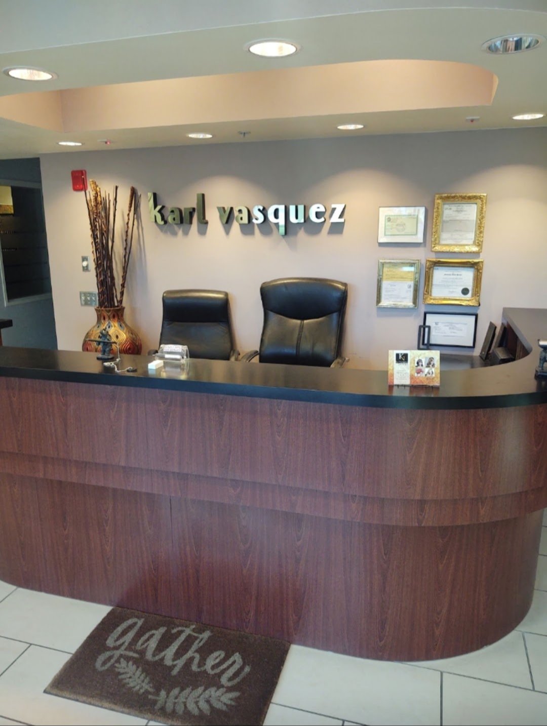 Karl Vasquez reception desk with backlit signage